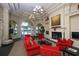 Community clubhouse lounge with fireplace and red sofas at 13836 Karina St, Venice, FL 34293