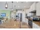 Modern kitchen features granite countertops and white cabinets at 13836 Karina St, Venice, FL 34293
