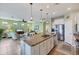 Open kitchen with granite island and stainless steel appliances at 13836 Karina St, Venice, FL 34293