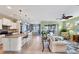 Open kitchen with white cabinets and granite countertops at 13836 Karina St, Venice, FL 34293