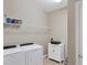 Laundry room with washer, dryer, and shelving at 13836 Karina St, Venice, FL 34293