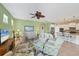 Open living room featuring a neutral color palette, comfortable seating, and a large TV at 13836 Karina St, Venice, FL 34293
