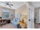 Cozy office space with a comfortable sofa, desk, and ceiling fan at 13836 Karina St, Venice, FL 34293