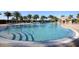 Relaxing community pool with palm trees and lounge chairs at 13836 Karina St, Venice, FL 34293