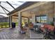 Covered patio with seating area and lovely lake view at 13836 Karina St, Venice, FL 34293