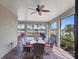 Relaxing screened patio with wicker furniture and lake view at 13836 Karina St, Venice, FL 34293