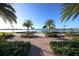 Serene waterfront walkway with lush landscaping at 13836 Karina St, Venice, FL 34293