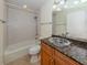 Updated bathroom with granite vanity and tiled shower/tub combo at 157 Tampa E Ave # 407, Venice, FL 34285