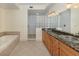 Elegant bathroom with double vanity, granite countertop, and large shower at 157 Tampa E Ave # 407, Venice, FL 34285