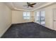 Spacious bedroom with carpeting, plantation shutters and ceiling fan at 157 Tampa E Ave # 407, Venice, FL 34285