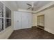 Guest bedroom with wood flooring, plantation shutters and ceiling fan at 157 Tampa E Ave # 407, Venice, FL 34285