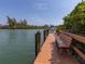 Community dock with bench overlooking the water at 157 Tampa E Ave # 407, Venice, FL 34285