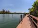 Scenic community dock with a bench and calm waters at 157 Tampa E Ave # 407, Venice, FL 34285