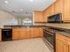 Modern kitchen with granite countertops, stainless steel appliances, and light wood cabinets at 157 Tampa E Ave # 407, Venice, FL 34285