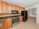 Well-equipped kitchen with stainless steel appliances and wood cabinets at 157 Tampa E Ave # 407, Venice, FL 34285