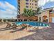 Inviting community pool with lounge chairs and palm trees at 157 Tampa E Ave # 407, Venice, FL 34285