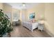 Bedroom with daybed, desk and wood flooring at 1630 Monarch Dr, Venice, FL 34293