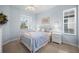 Light and airy bedroom with full-size bed at 1630 Monarch Dr, Venice, FL 34293