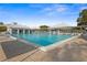 Inviting community pool with plenty of lounge chairs for sunbathing at 1630 Monarch Dr, Venice, FL 34293