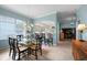 Bright dining area with glass table, four chairs, and a view into the kitchen at 1630 Monarch Dr, Venice, FL 34293