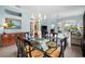 Bright dining room with glass table, chandelier, and view into living room at 1630 Monarch Dr, Venice, FL 34293