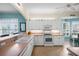 Clean and bright kitchen with white cabinets and updated appliances at 1630 Monarch Dr, Venice, FL 34293