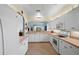 Bright kitchen with white cabinets, tile floors, and stainless steel appliances at 1630 Monarch Dr, Venice, FL 34293