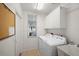 Laundry room with washer, dryer and storage at 1630 Monarch Dr, Venice, FL 34293