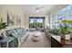Relaxing sunroom with comfy sofas and access to backyard patio at 1630 Monarch Dr, Venice, FL 34293