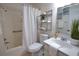 Clean bathroom with a shower/tub combo, vanity, and shelving unit at 1640 Stickney Point Rd # 202, Sarasota, FL 34231