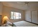 Bedroom with a comfortable bed, ceiling fan, and window with exterior view at 1640 Stickney Point Rd # 202, Sarasota, FL 34231