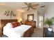 Well-lit bedroom with a wooden bed frame and ceiling fan at 1640 Stickney Point Rd # 202, Sarasota, FL 34231