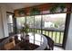 Bright breakfast nook with glass-top table and wicker chairs, overlooking a patio at 1640 Stickney Point Rd # 202, Sarasota, FL 34231