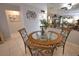 Close-up view of dining table with glass top and chairs at 1640 Stickney Point Rd # 202, Sarasota, FL 34231