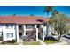 Two-story building with Spanish tile roof and stairs at 1640 Stickney Point Rd # 202, Sarasota, FL 34231