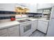 Well-equipped kitchen with white cabinets and electric range at 1640 Stickney Point Rd # 202, Sarasota, FL 34231
