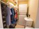Stackable washer and dryer in a well-organized laundry closet at 1640 Stickney Point Rd # 202, Sarasota, FL 34231