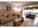 Living area with comfortable sofas, coffee table, and patio view at 1640 Stickney Point Rd # 202, Sarasota, FL 34231