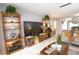 Bright living room featuring a large TV, comfortable seating, and built-in shelving at 1640 Stickney Point Rd # 202, Sarasota, FL 34231