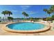 Circular pool with surrounding lounge chairs and waterfront view at 1640 Stickney Point Rd # 202, Sarasota, FL 34231