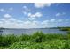 Peaceful waterfront view with lush vegetation at 1640 Stickney Point Rd # 202, Sarasota, FL 34231