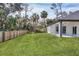 Large grassy backyard with wooden fence and lush landscaping at 16443 Lagore Ave, Port Charlotte, FL 33954