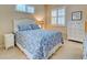 Bedroom with a queen bed, window shutters and white dresser at 1655 Lancashire Dr # 1655, Venice, FL 34293
