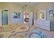 Primary bedroom with dresser, ensuite bathroom access, and sitting area at 1655 Lancashire Dr # 1655, Venice, FL 34293