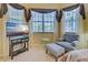 Relaxing sitting area in bedroom with comfy armchair and ottoman at 1655 Lancashire Dr # 1655, Venice, FL 34293