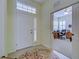 Bright entryway with white door and view into home office at 1655 Lancashire Dr # 1655, Venice, FL 34293