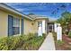 Front entry with walkway, blue shutters and white pillars at 1655 Lancashire Dr # 1655, Venice, FL 34293