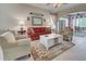 Comfortable living room with a red sofa and white coffee table at 1655 Lancashire Dr # 1655, Venice, FL 34293