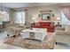 Relaxing living room, featuring a red couch and cream armchairs at 1655 Lancashire Dr # 1655, Venice, FL 34293