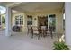 Covered patio with outdoor furniture, perfect for dining al fresco at 1655 Lancashire Dr # 1655, Venice, FL 34293